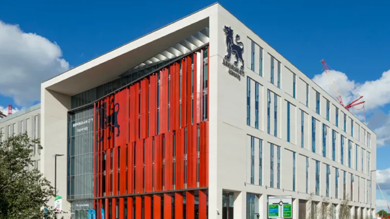 BCU A four-storey white building with a red front.