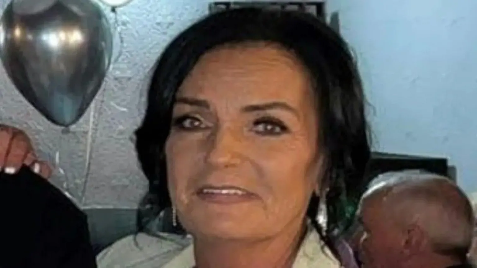 Police scotland Ann Coll, a woman with dark hair. She is wearing makeup and there is balloons behind her.