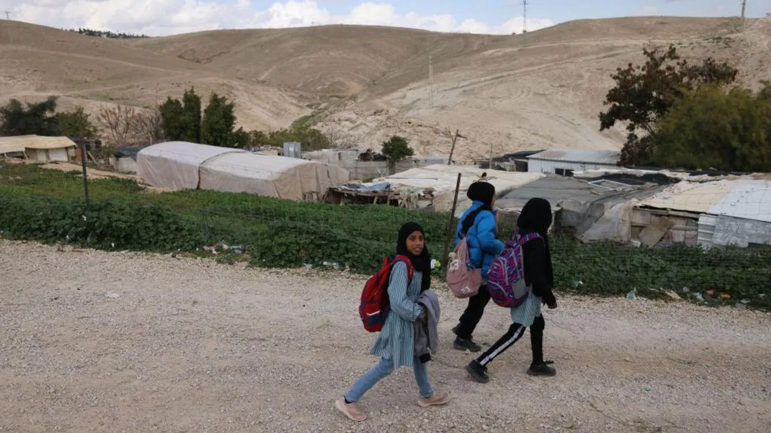 AFP File photo showing Palestinian children walk around the Bedouin village of Khan al-Ahmar, east of Jerusalem, in the occupied West Bank (30 January 2023)