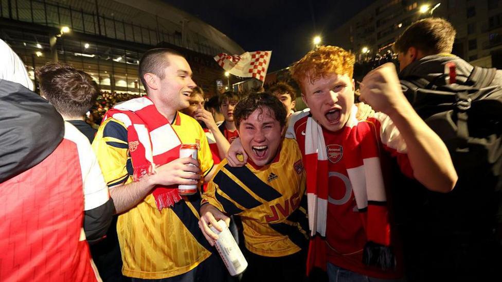 Arsenal fans celebrate the Gunners winning the title