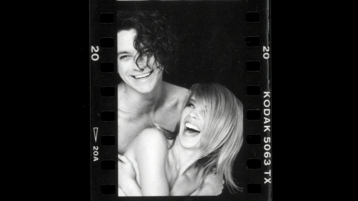 Kylie and Michael Hutchence laugh in a Kodak negative-style photograph.