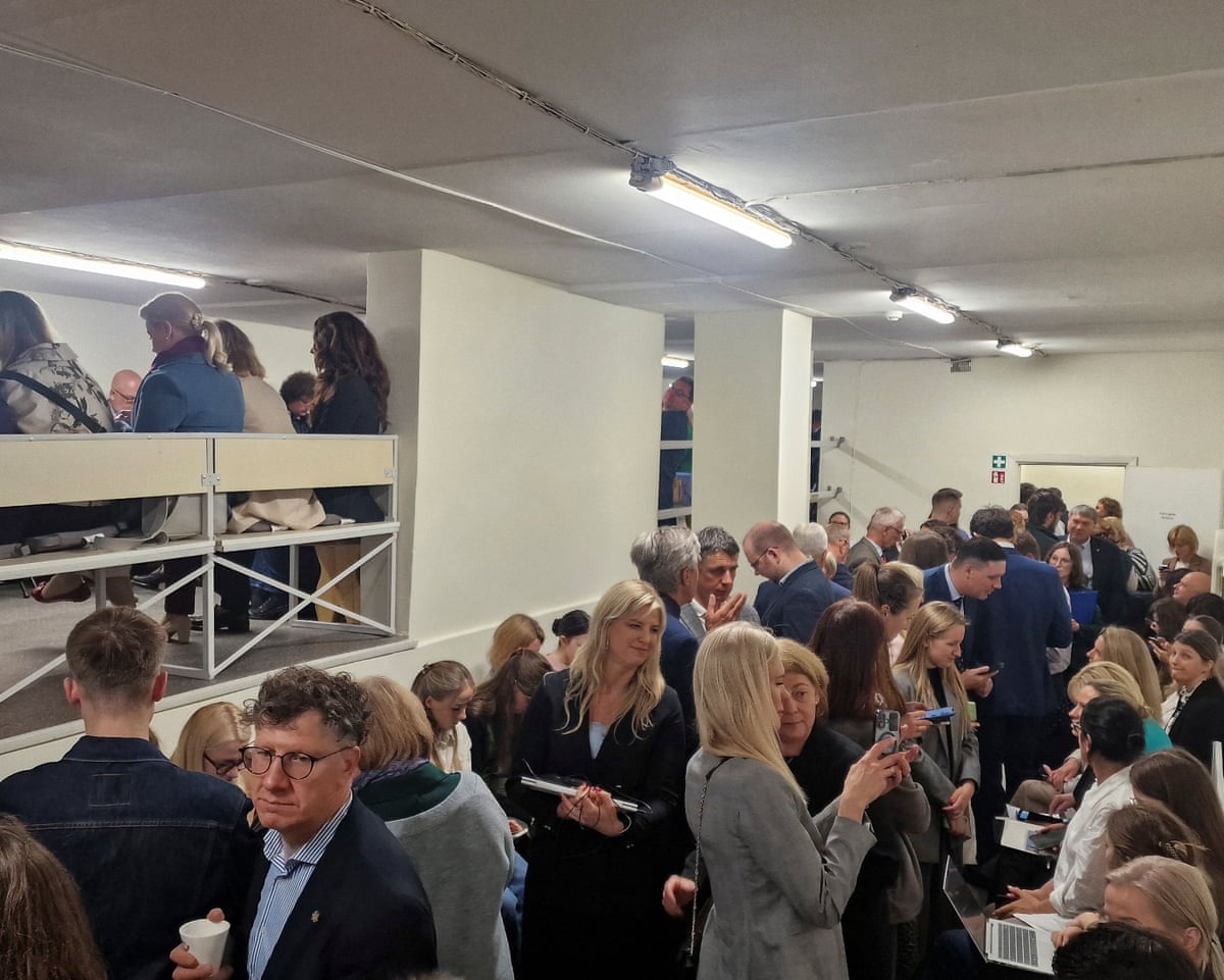 People gather inside a shelter at the Lithuanian parliament after an 'air danger' warning, in Vilnius, Lithuania.
