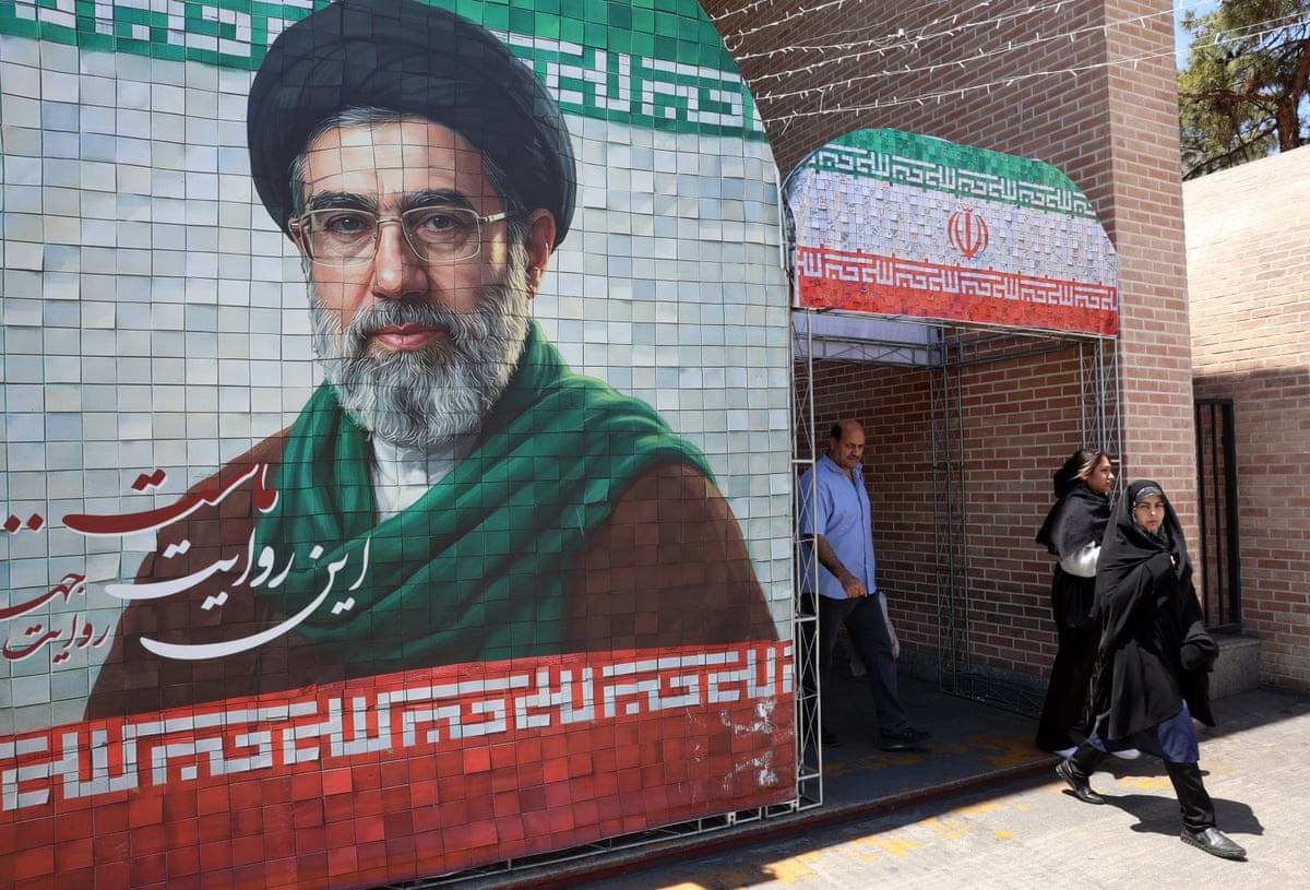 Iranians walk past a picture of Iranian supreme leader Ayatollah Mojtaba Khamenei in a street in Tehran, Iran.