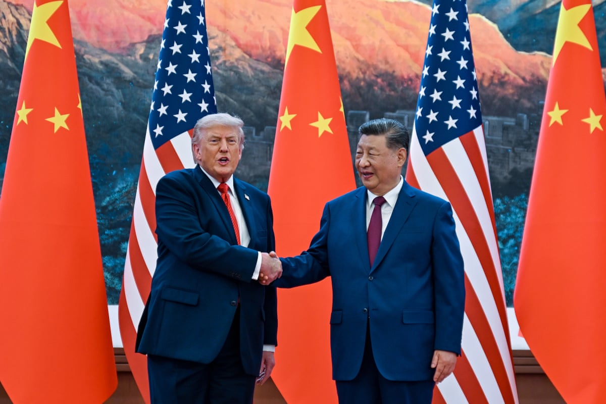 The Chinese president, Xi Jinping, right, shakes hands with Donald Trump at the Great Hall of the People in Beijing.