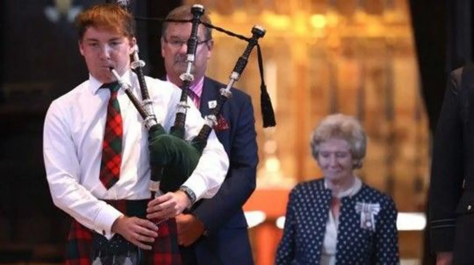 Alison Wild A teenager with red hair playing the bagpipes