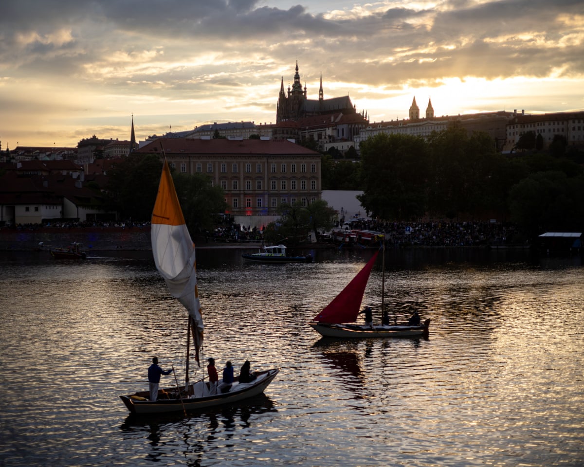 Boats cruise the Vltava river during the Navalis celebrations, with Prague Castle in the background, in Prague, Czech Republic.