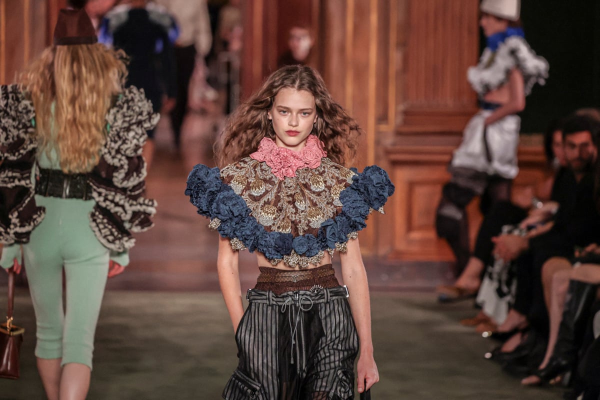 A model in a flamboyant top on the runway