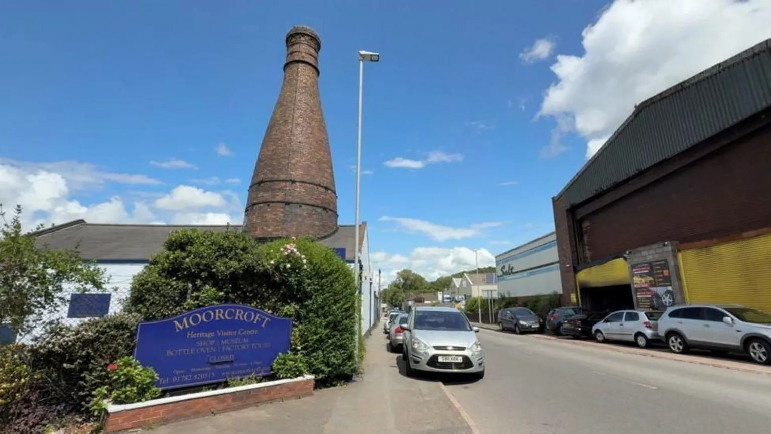 The front entrance to the Moorcroft factory in Stoke-on-Trent. A large blue sign on the side of the road says