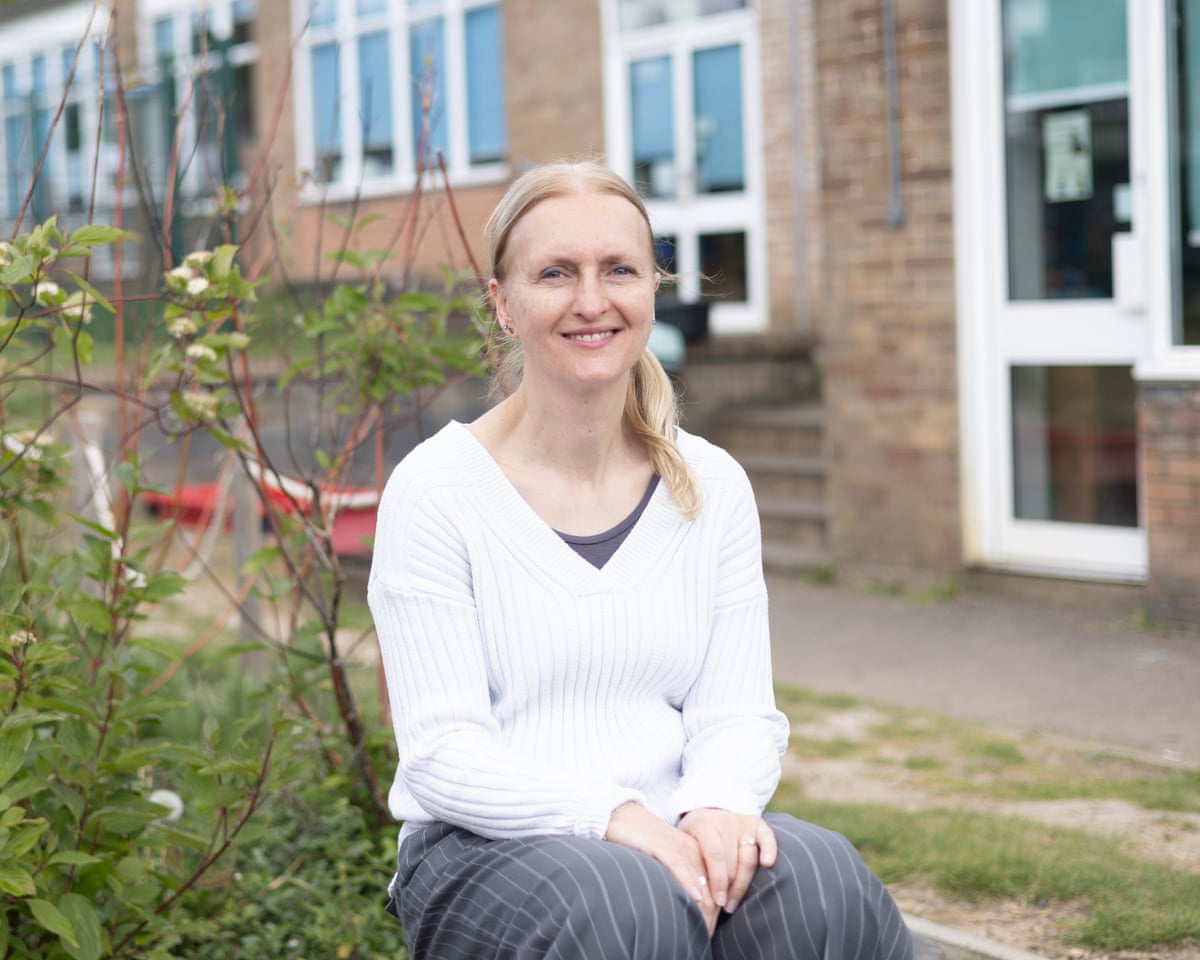 Maccie Dobbie, head teacher at St John’s CofE primary, sits outside a building.