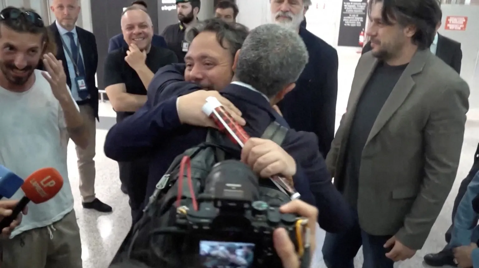 Italian lawmaker Dario Carotenuto is embraced by a relative 