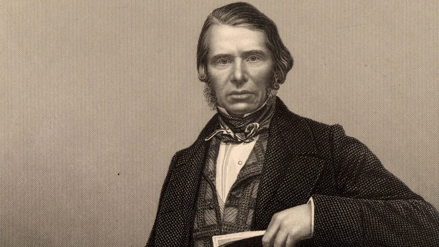 Sepia Image of Charles Edward Trevelyan, looking directly, with sideburns, cravate, checked waistcoat and jacket, holding a book