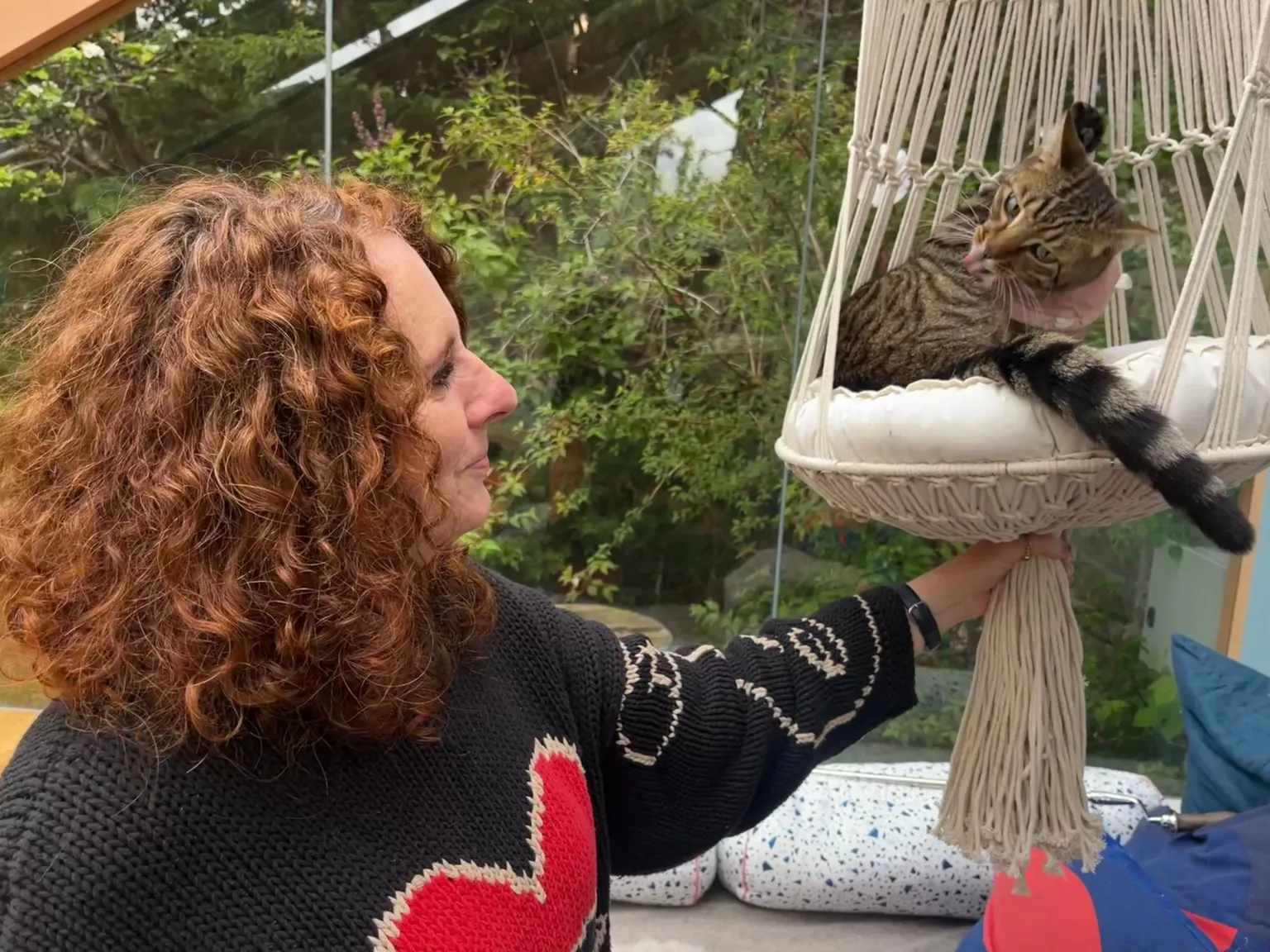 BBC/Katie Razzall Maggie O'Farrell in black jumper with red love heart looking at her cat