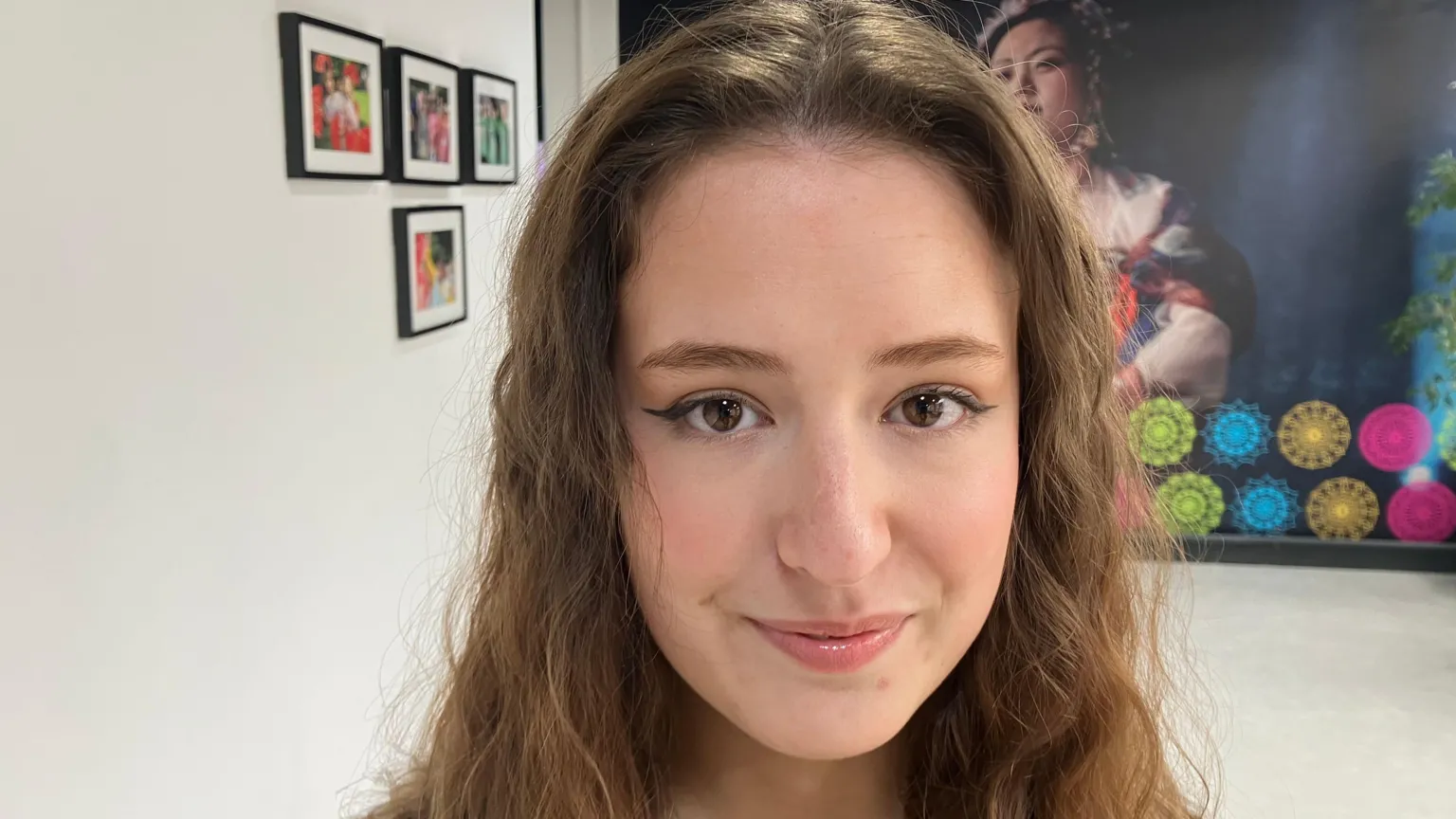 Rachel smiling at the camera. She has long wavy light brown hair. 