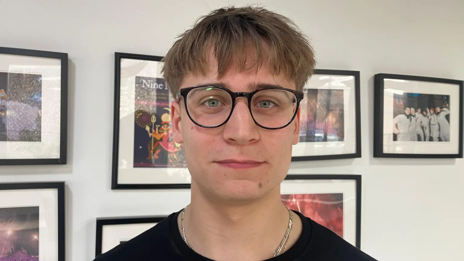 Martim smiling at the camera. He is wearing a black top and round glasses. He has fair hair.