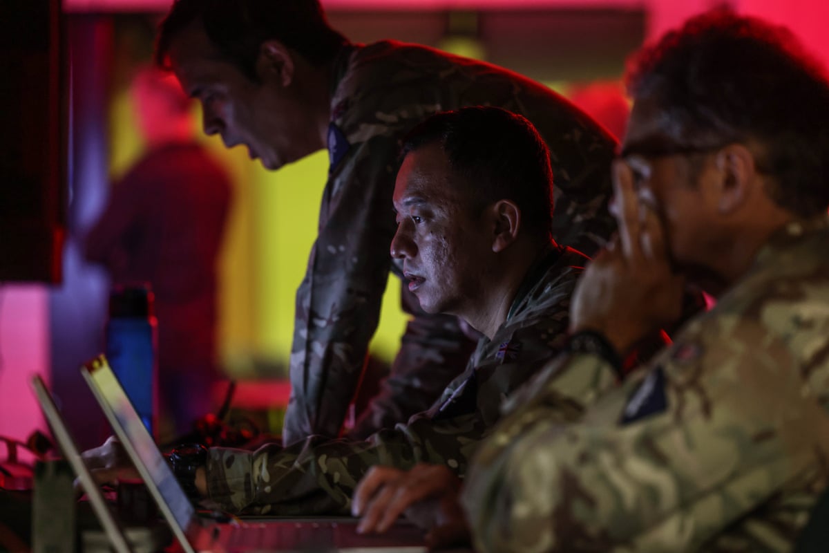 Soldiers sat at laptops in the makeshift command post