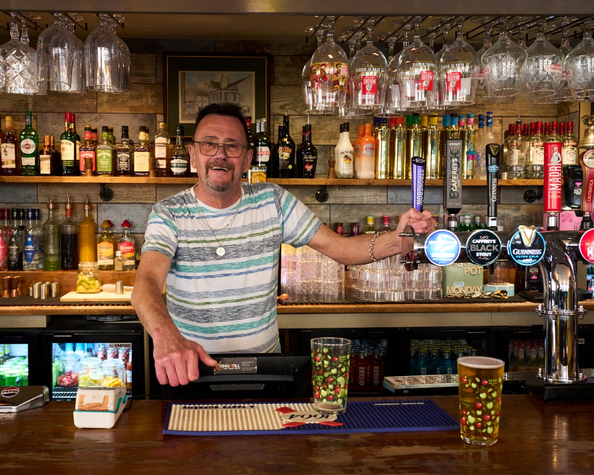 Chris Woodhead behind bar in pub