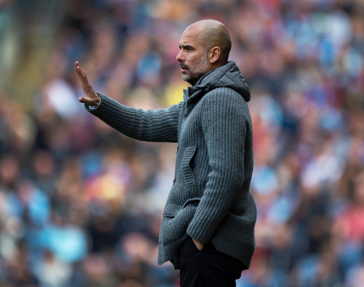 Pep Guardiola in a grey knit cardigan