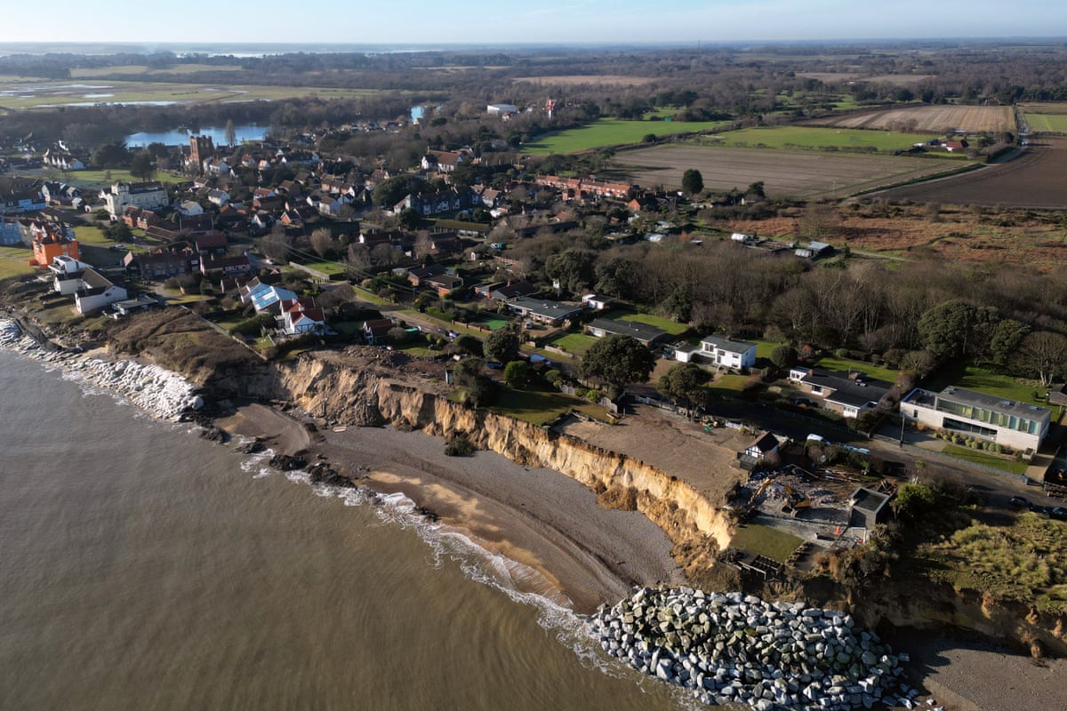Demolition is carried out on a home at risk of falling into the sea as a result of coastal erosion, in Thorpeness, Suffolk.