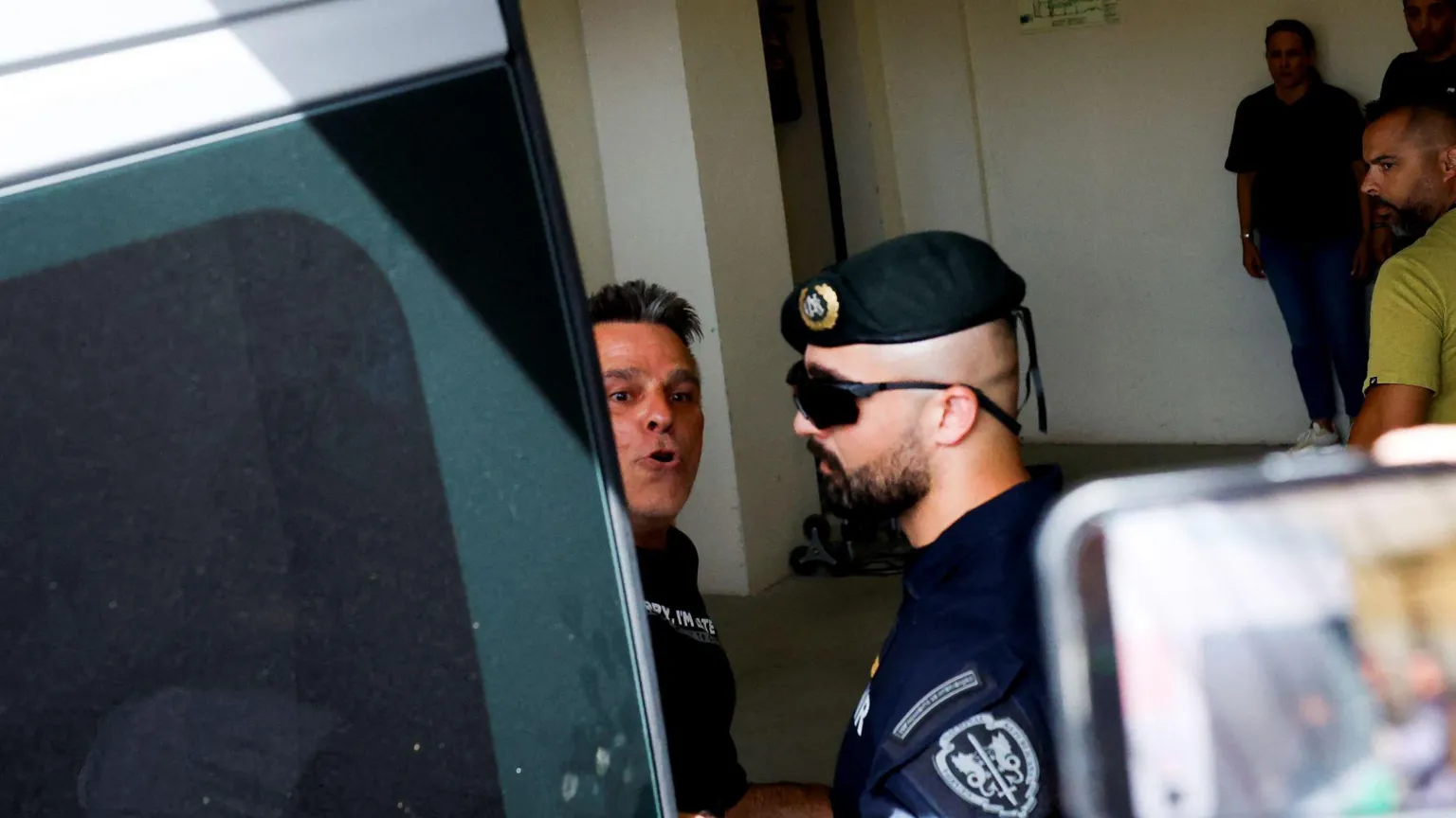  Frenchman Marc B arriving to the Setubal courthouse on Friday being escorted by a police officer.