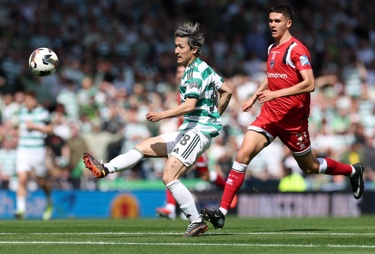 Lovely lob over the keeper: Daizen Maeda of Celtic scores his team's first goal.