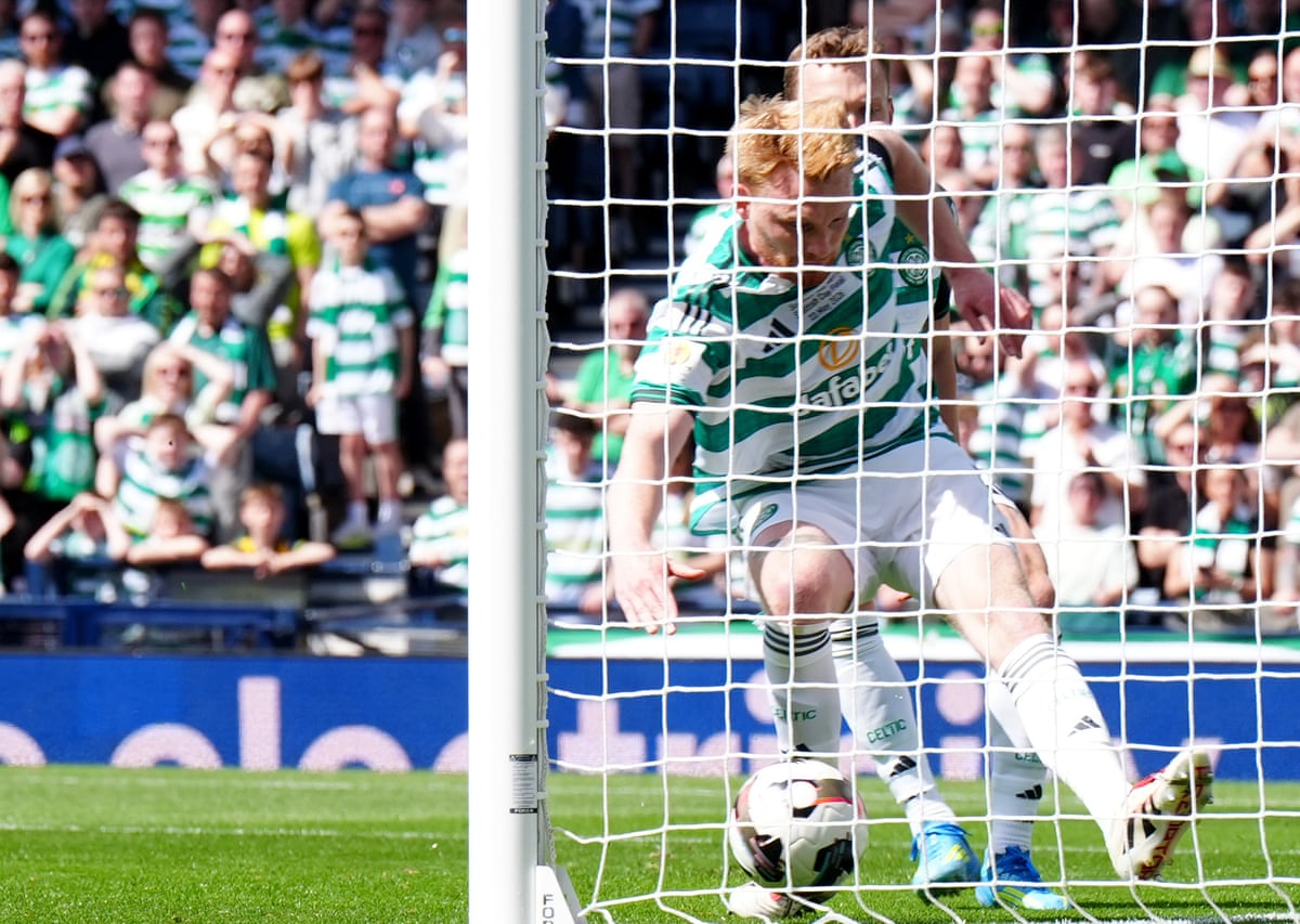 Celtic's Liam Scales clears the ball off his own line.