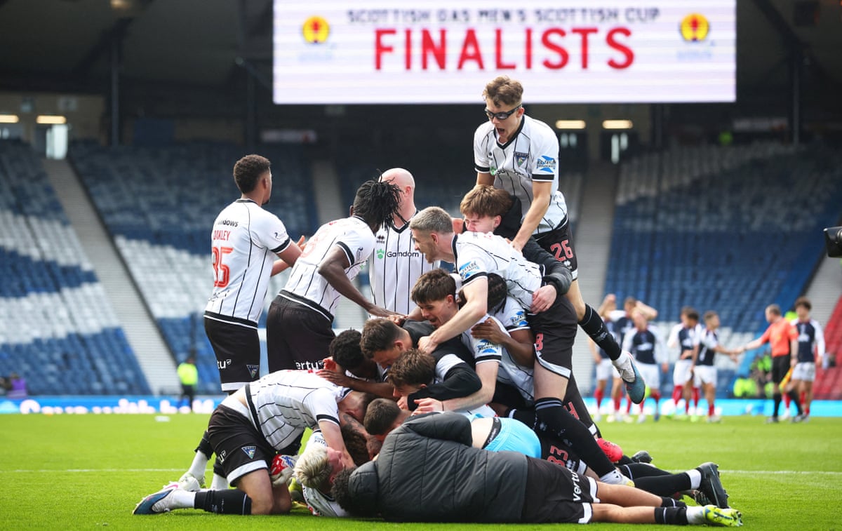 Dunfermline Athletic’s players enjoy a celebratory pile-on after beating Falkirk in a Scottish Cup semi-final penalty shoot-out.