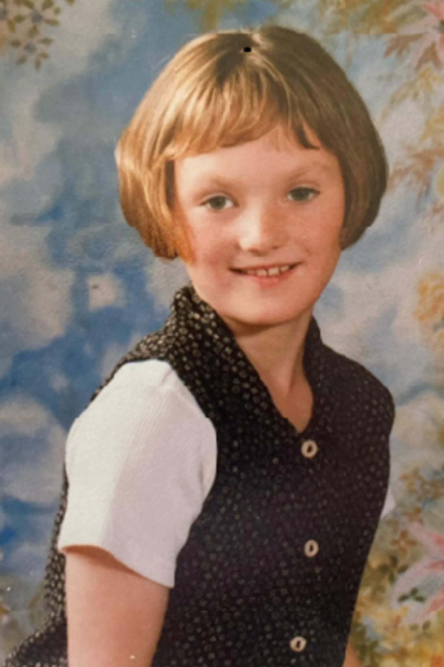 Michaela Allen Seven-year-old Michaela smiles at the camera in a professional looking photograph. Her brown hair is cut short and she is wearing a white t-shirt under a black spotted button-up top.