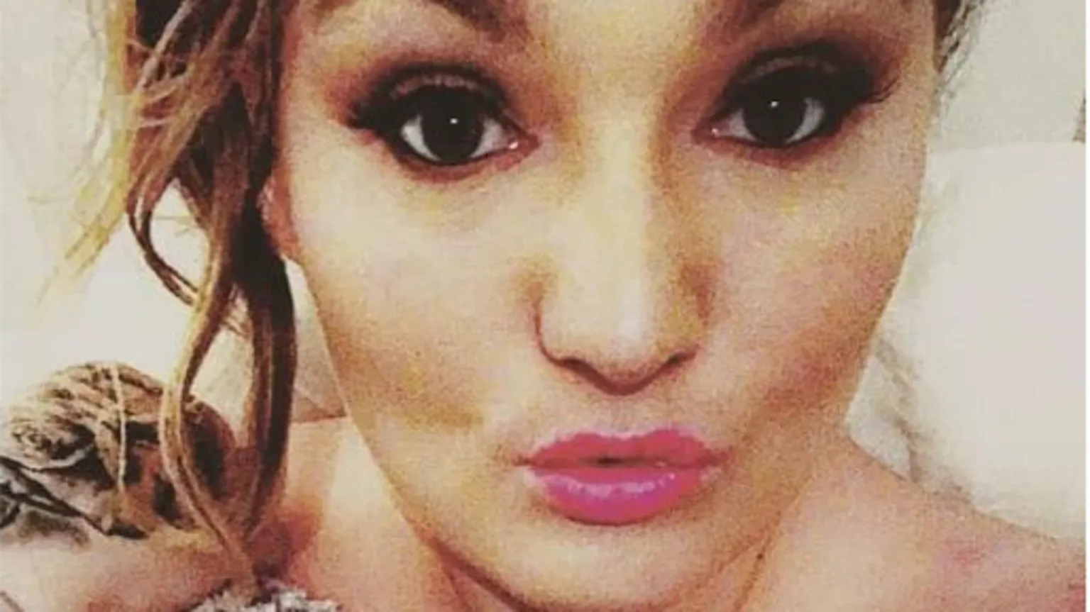 Michaela Allen A selfie of Michaela Allen, she is wearing pink lipstick and has her hair styled in an up do.