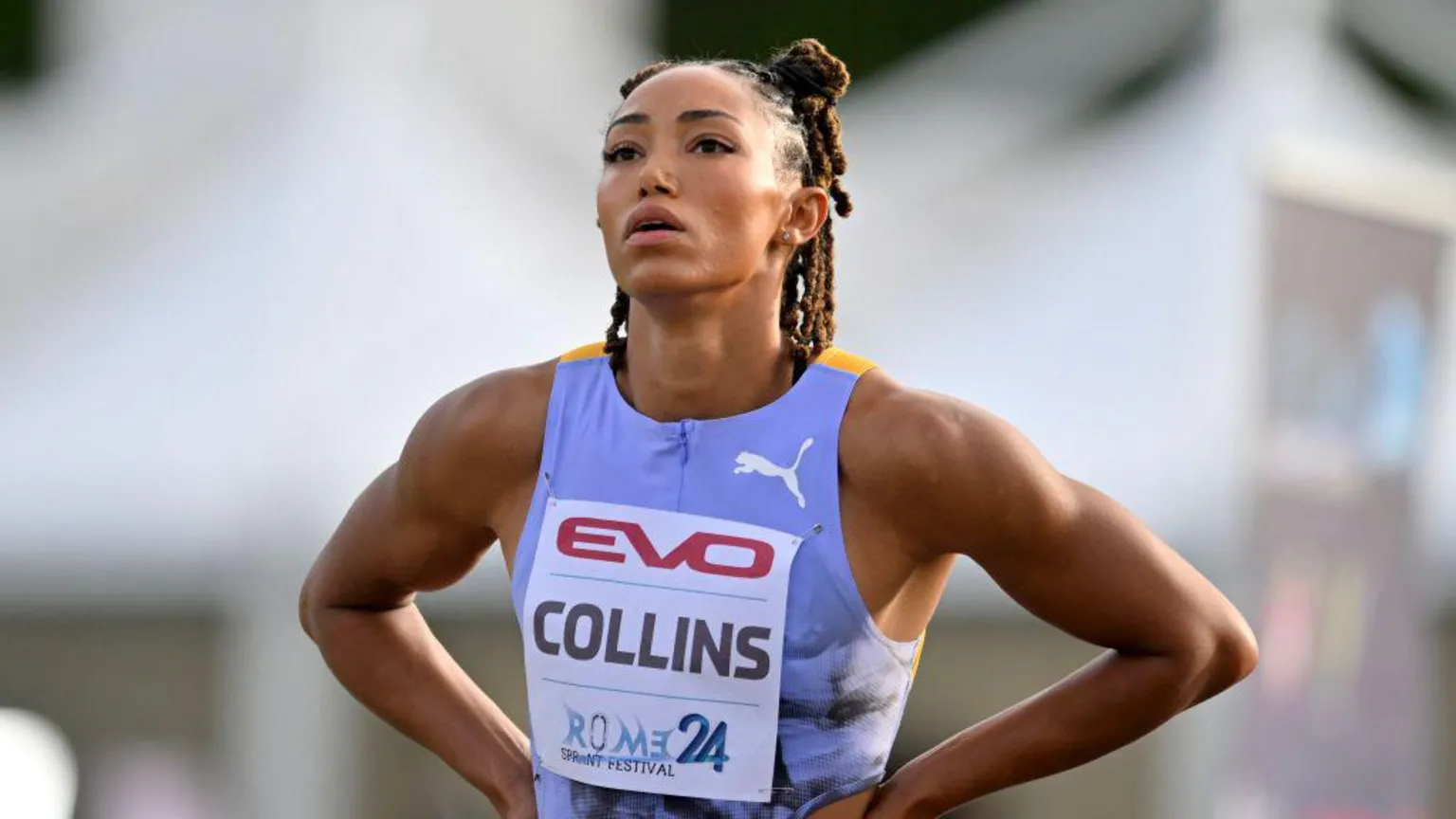 LightRocket/ Shania Collins of United States reacts after competing in a 100m race - she has her hands on her hips and is wearing a light purple vest.