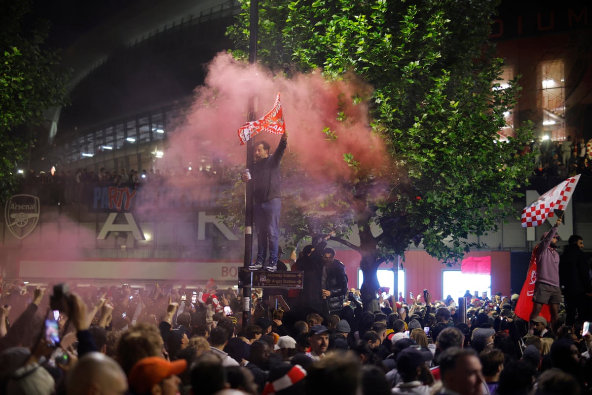 Arsenal fans celebrate outside the Emirates Stadium
