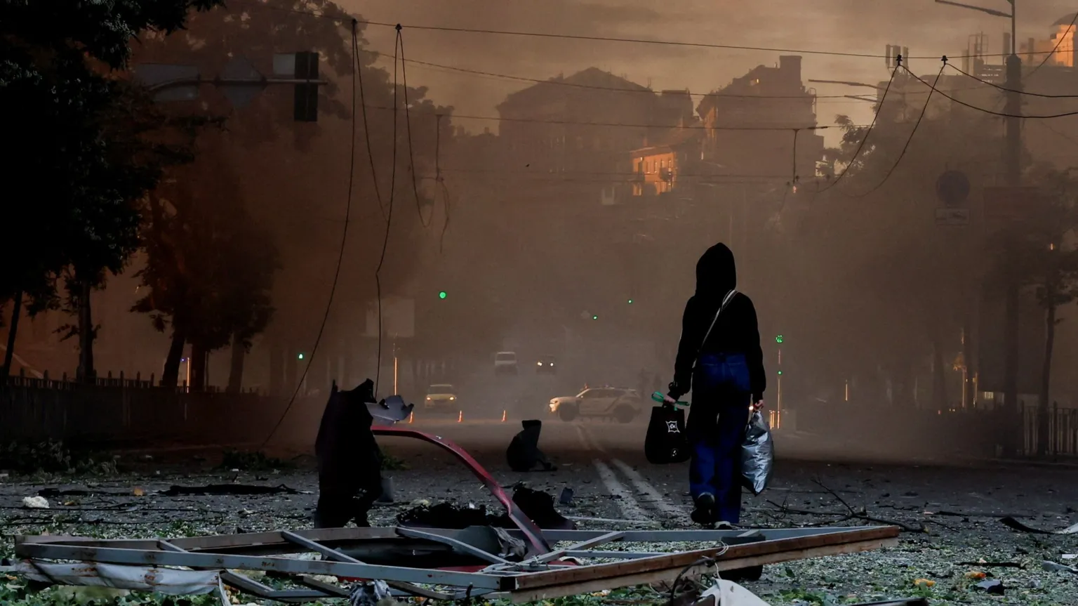  A person walks on a debris-scattered street in the aftermath of an overnight Russian missile and drone strike on Kyiv, Ukraine 24 May 2026.