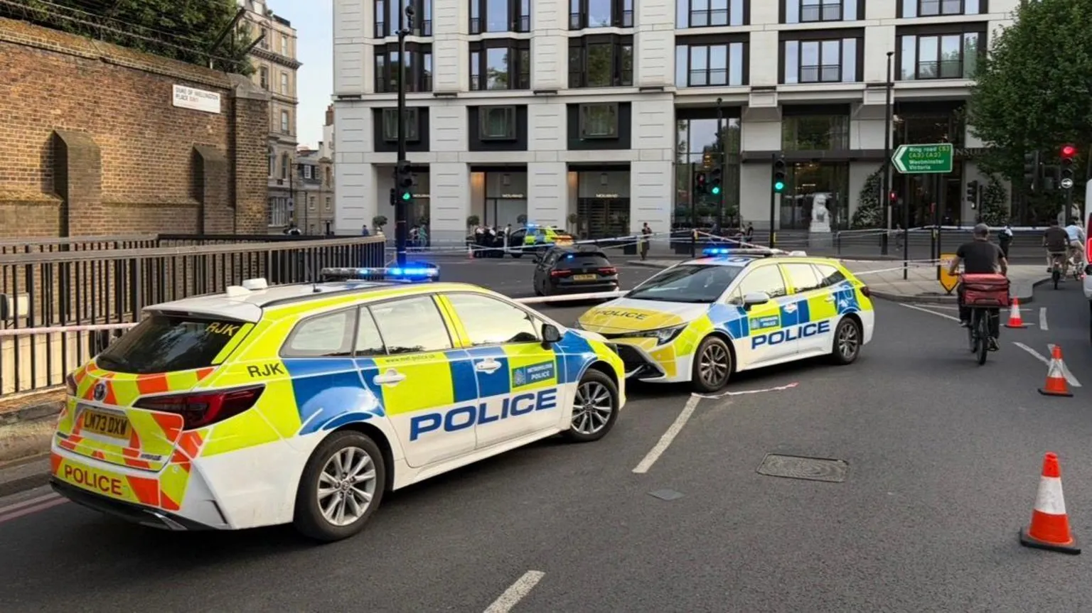 Two police cars are seen blocking off the cordon at Hyde Park Corner