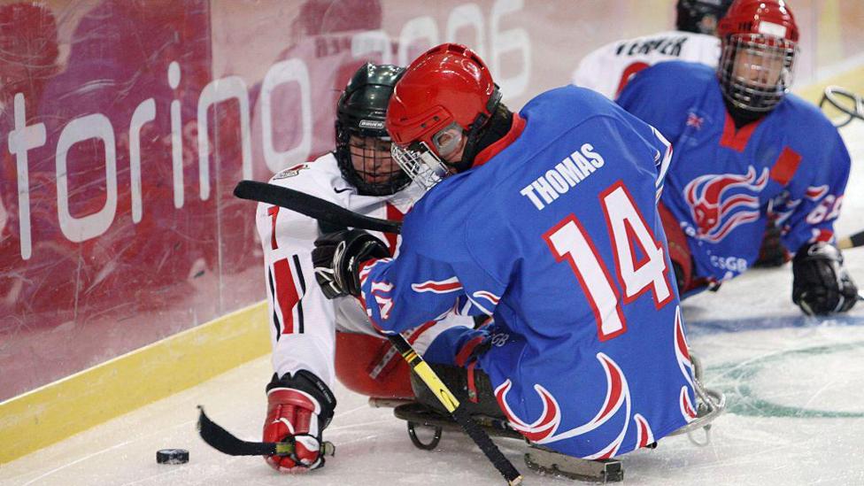 Marc Dorion (Canada) challenges Stephen Thomas of Great Britain at the 2006 Winter Paralympics
