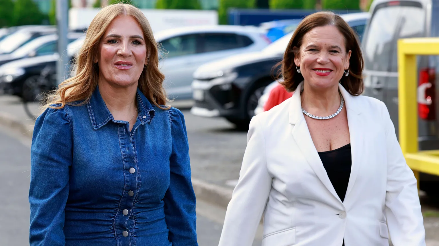  Janice Boylan, left, with long auburn hair, wearing a denim long sleeve top. She is standing beside Mary Lou McDonald, with shoulder length brown hair, wearing a black top and white blazer. 