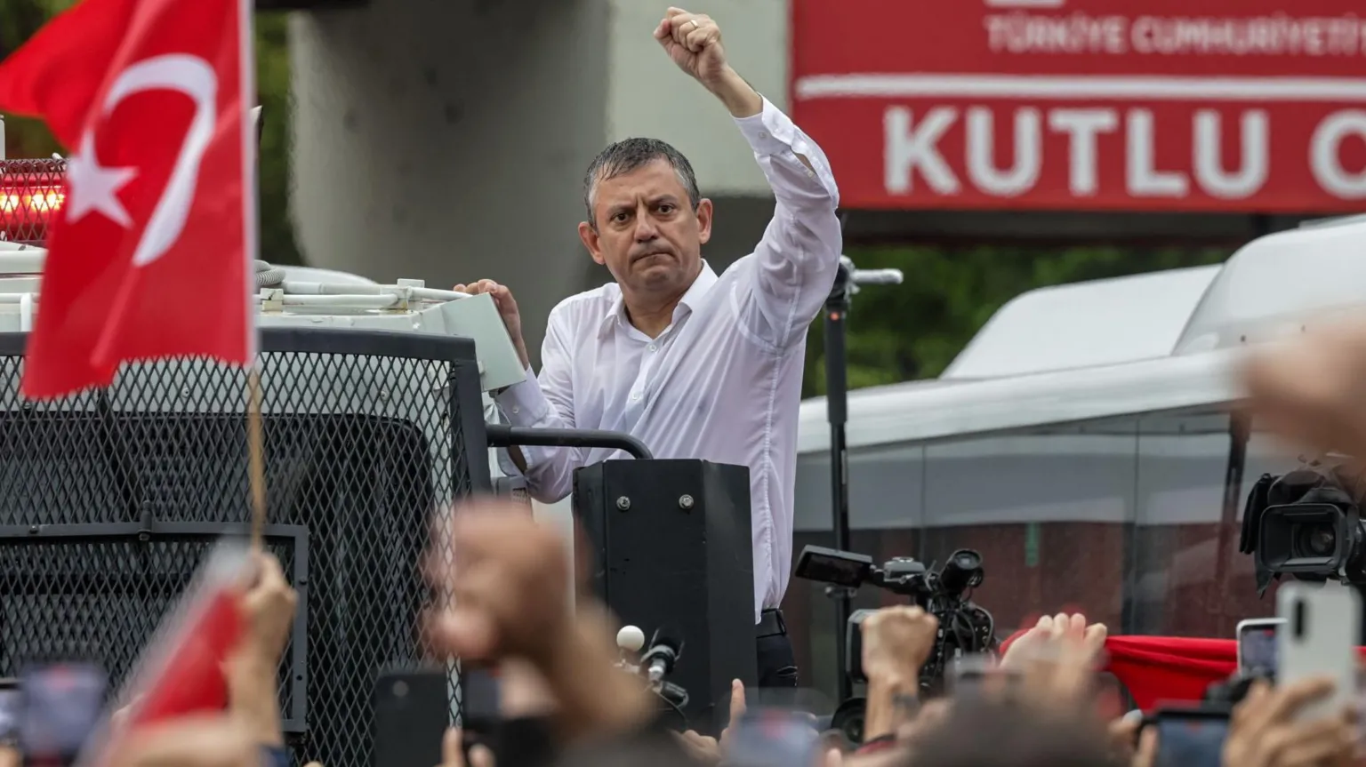  Ousted CHP leader Özgür Özel waves to supporters atop a police water cannon vehicle