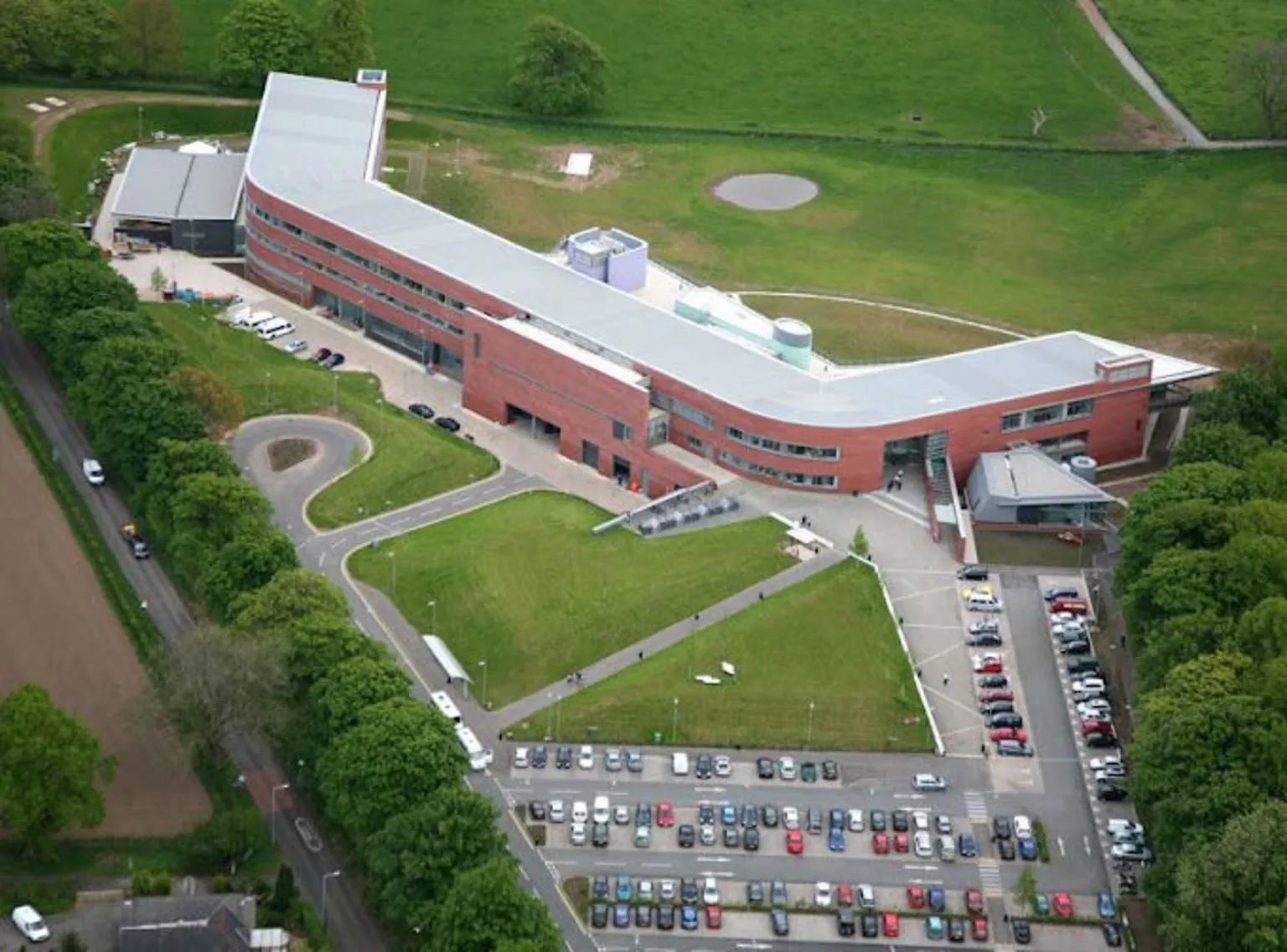 Dumfries and Galloway College An aerial view of Dumfries and Galloway College with car park outside and green fields around it