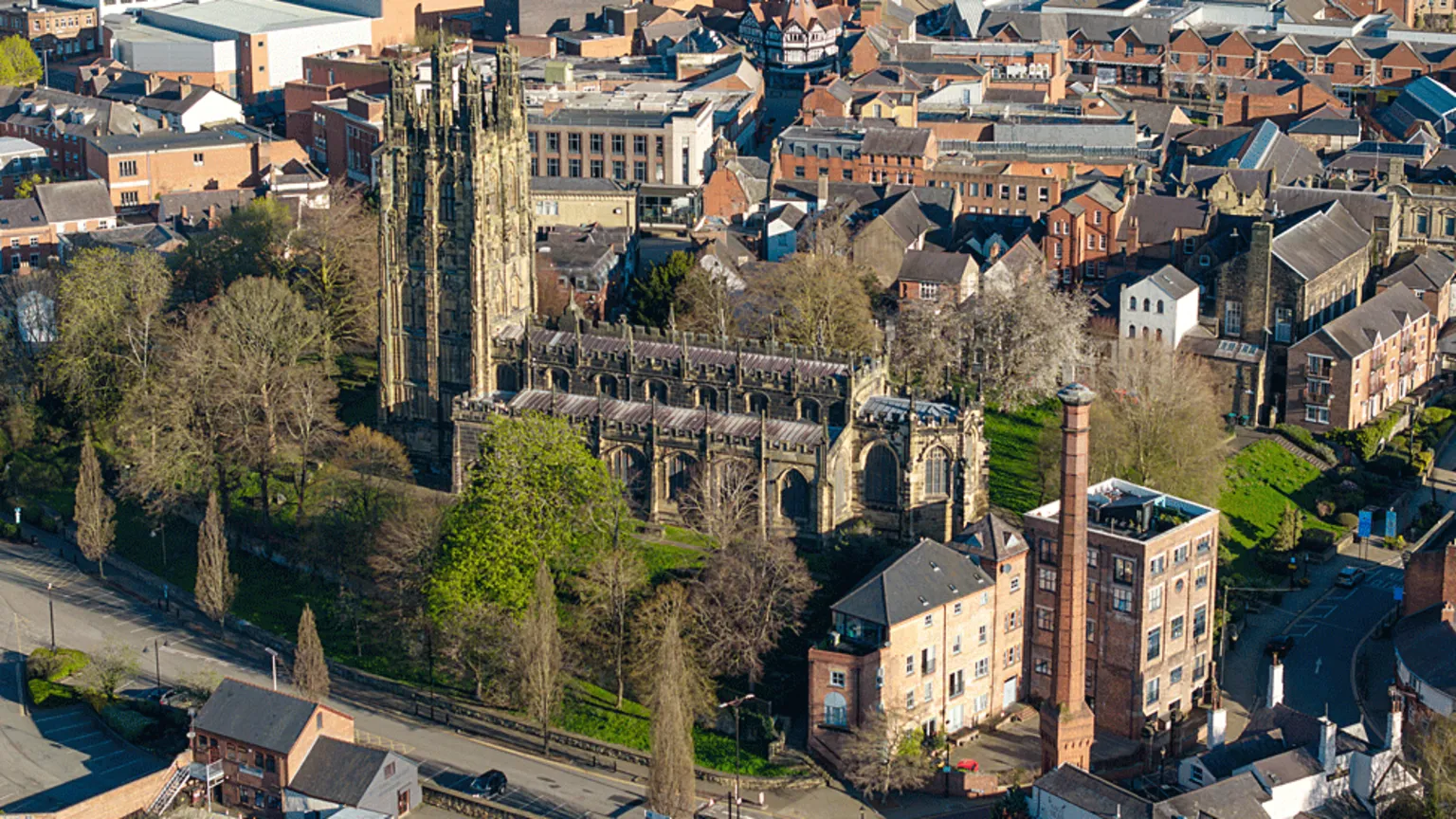Aerial view of tree-lined Wrexham's St Giles Parish Church in the city centre