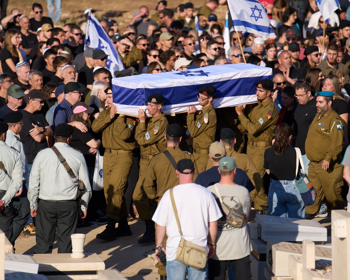 Israeli soldiers carry the casket of Staff Sgt Noam Hamburger, who was killed in a Lebanese drone attack on northern Israel, during his funeral in Atlit, Israel, on Sunday