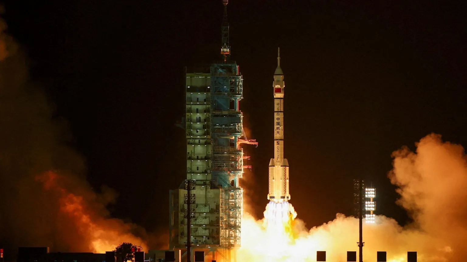  China's Shenzhou-23 launches into space at night, with its rocket boosters emitting gigantic flames and thick white smoke