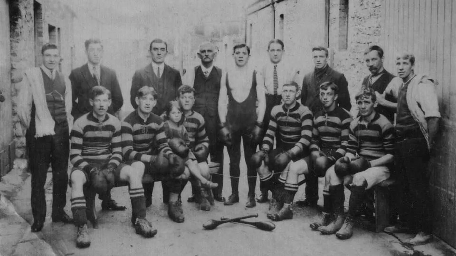 Penarth Civic Society A group of people at Stan's family's boxing club in Penarth. In the back row are suited men, whilst in the front are youths all wearing boxing gloves