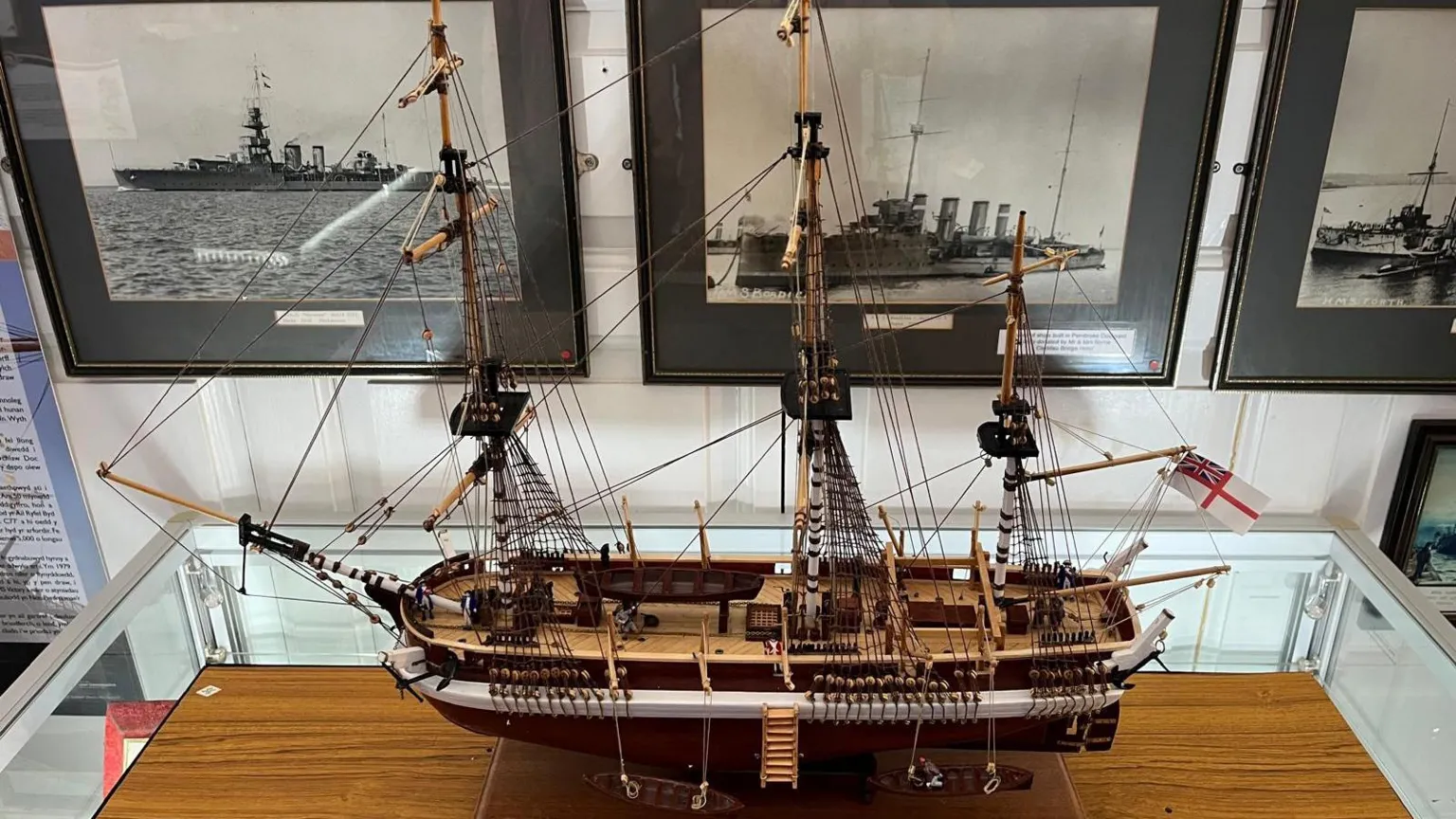 Pembroke Dock Heritage Centre A model of HMS Erebus. It was a large naval ship, made of wood, with large wooden masts and a flag at the back.
