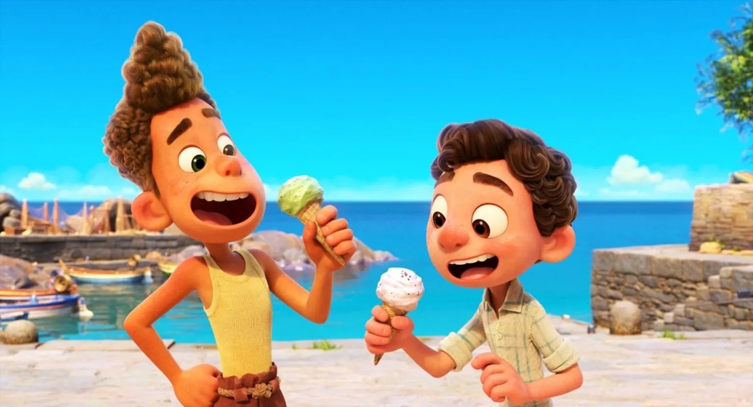 Disney/Pixar Still from the film Luca - two animated characters hold ice cream cones. They are standing at a small harbour with boats and yachts behind them.