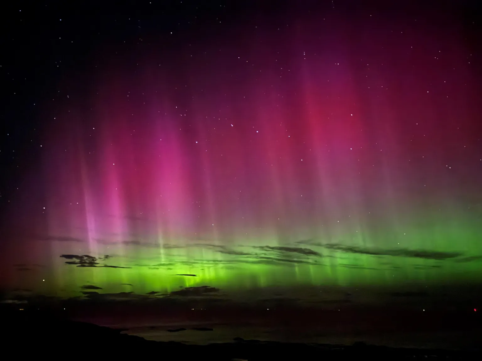 Carol More The aurora seen from across the Moray Firth at Hopeman. Clouds are illuminated by the display of colour. Carole More took this picture as her and her husband looked across the Moray Firth at Hopeman. She said they were