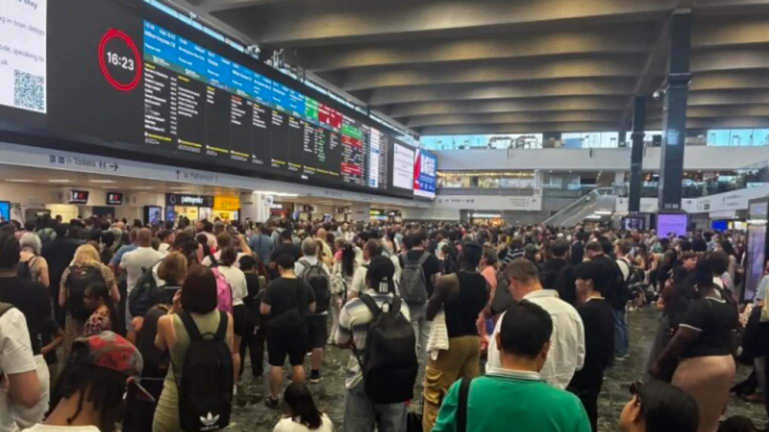 Commuters at London Euston station gathered to look at train schedules