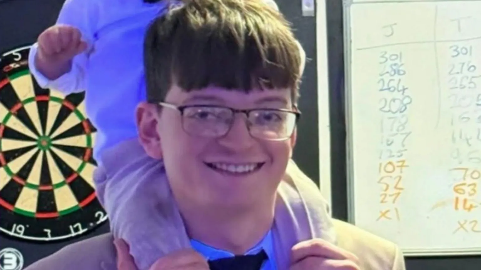 Supplied A man with a child on his shoulders. He is wearing a suit and glasses.