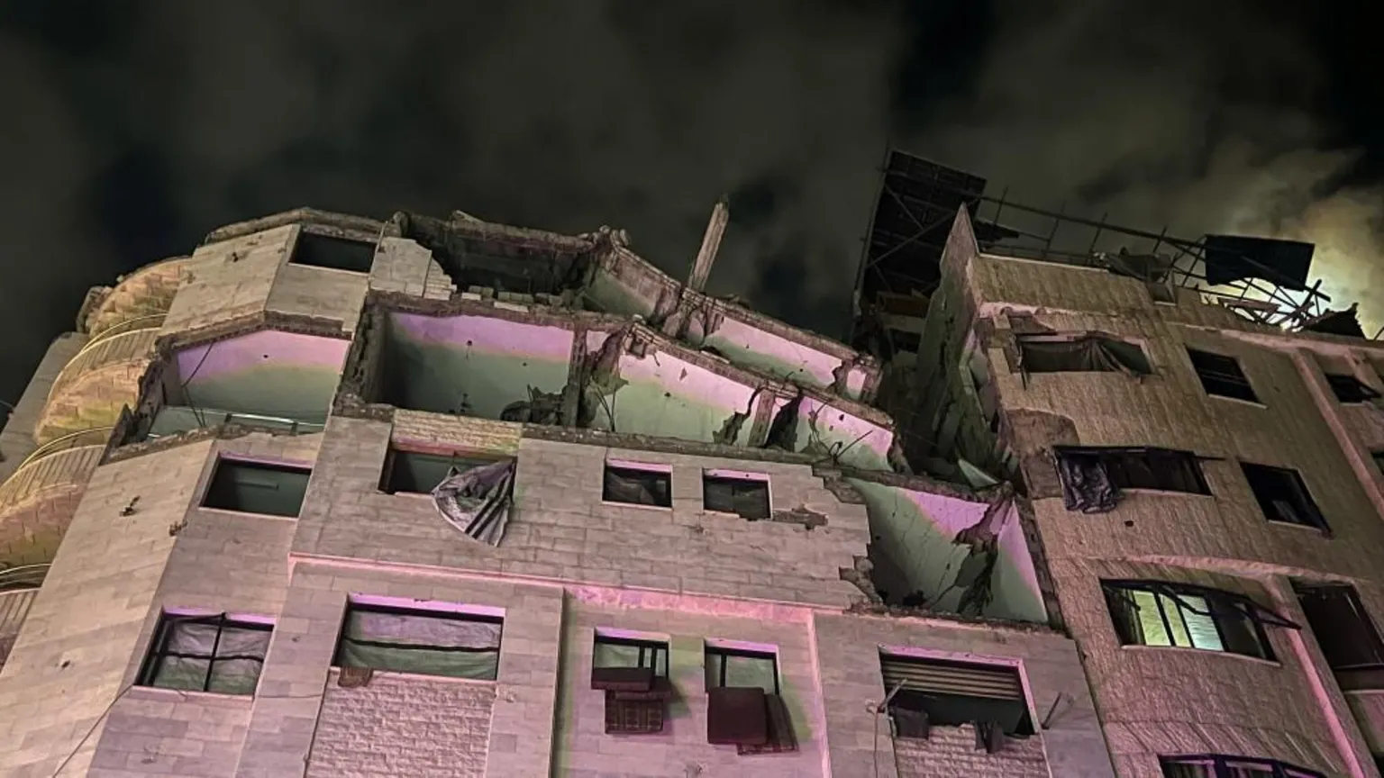  A block of flats damaged by an air strike pictured at night