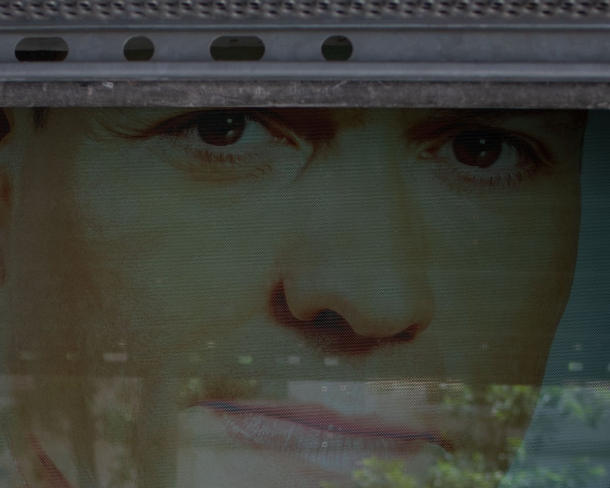 A portrait of Spanish prime minister Pedro Sánchez is partially obscured by a shutter on the main facade of the PSOE headquarters in Madrid.