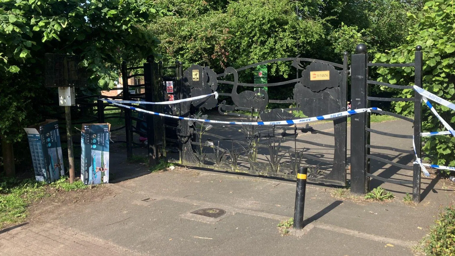 Iron gates covered in police tape.