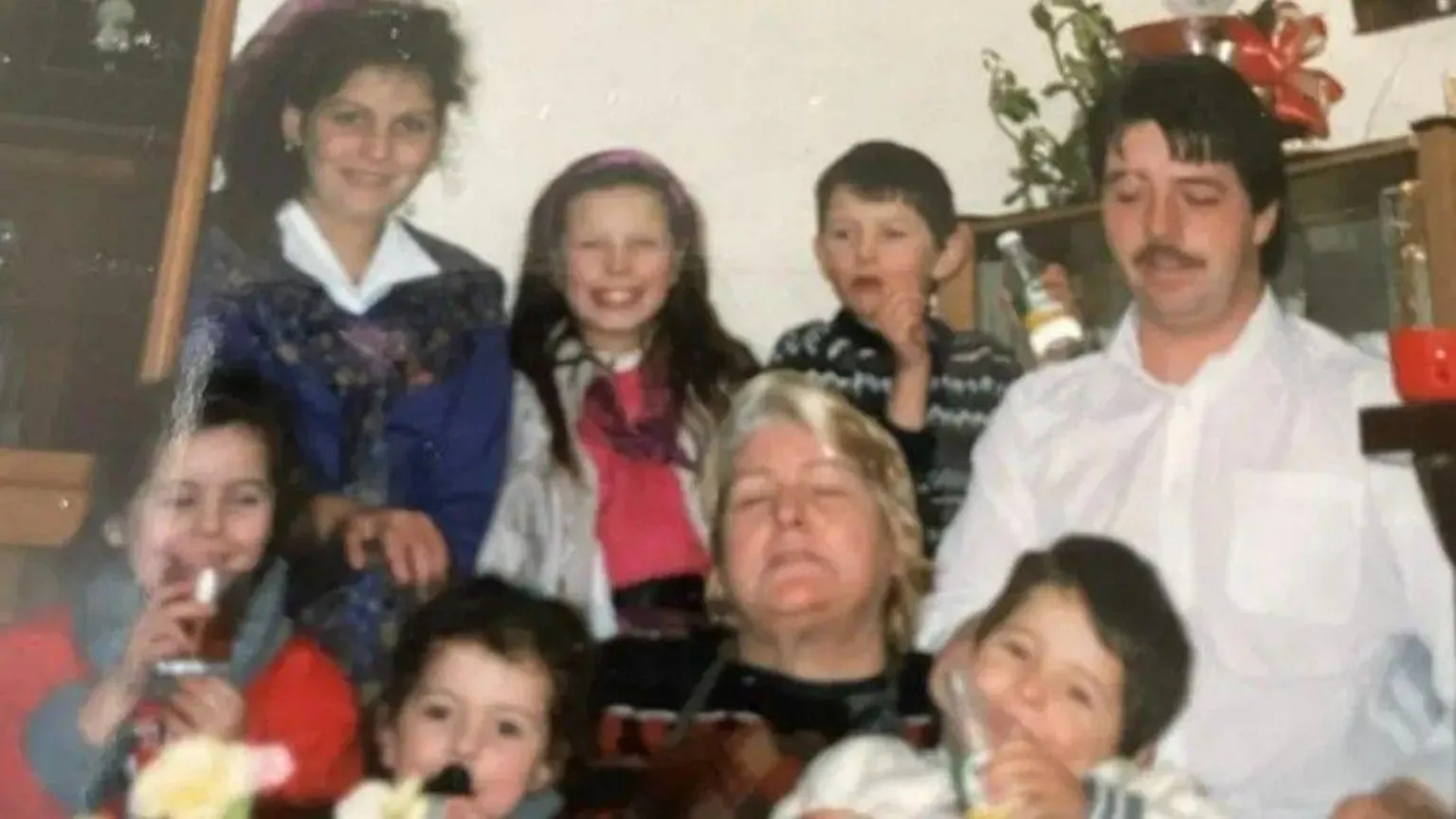Jeanitta McCabe An old image of a man and woman surrounded by six children. 