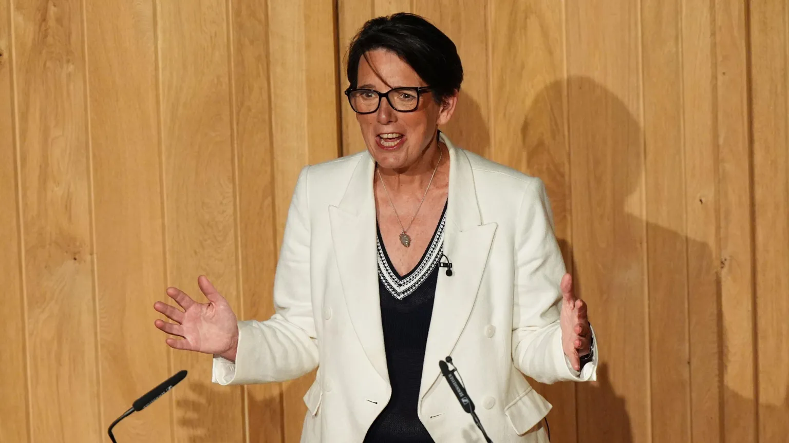 GCHQ director Anne Keast-Butler giving the spy agency's inaugural annual lecture. She is wearing a white blazer and black shirt. 